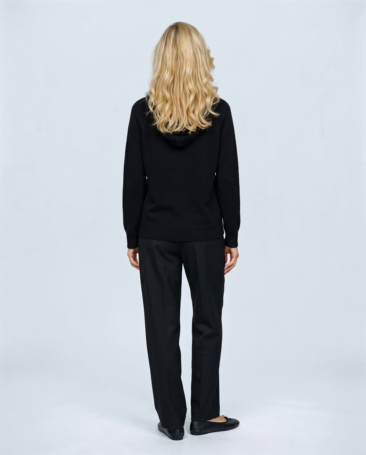 The Relaxed Knit Hoodie in Black, back view on a non-pregnant model