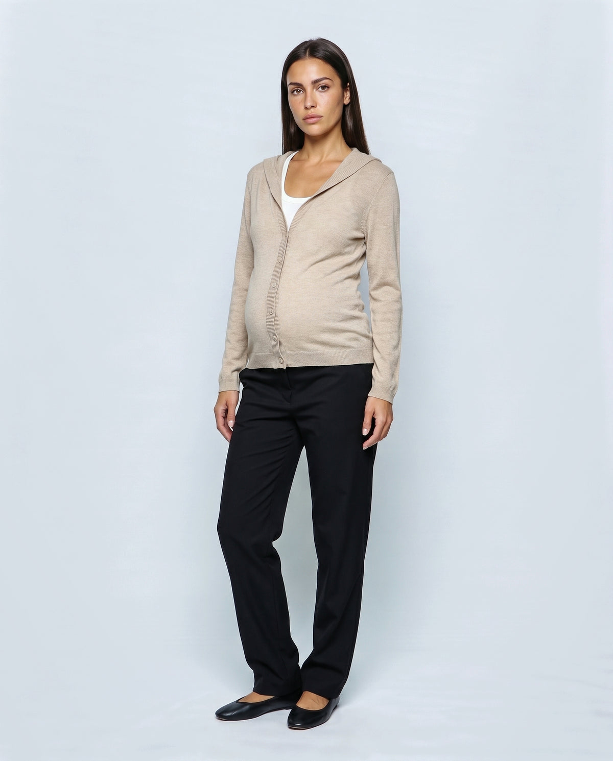The Hooded Button Cardigan in Beige, closed over the bump